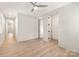 Spacious bedroom with hardwood floors, ceiling fan, neutral wall color and natural light at 2924 Springs Dr, Charlotte, NC 28226