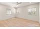 Well-lit bedroom with hardwood floors and windows offering natural light, and neutral wall color at 2924 Springs Dr, Charlotte, NC 28226