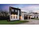 Modern two-story home featuring a three-car garage, dark trim, and a well-manicured lawn at 2924 Springs Dr, Charlotte, NC 28226