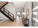 Elegant foyer with hardwood floors, modern staircase, and stylish console table at 2924 Springs Dr, Charlotte, NC 28226