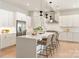 Modern white kitchen with a large island, stainless steel appliances, and pendant lighting at 2924 Springs Dr, Charlotte, NC 28226