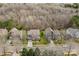 An aerial view shows multiple homes and properties in a neighborhood near a wooded area at 3203 Thayer Dr, Waxhaw, NC 28173