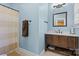 Bathroom featuring a wood vanity, framed mirror, and a shower with a neutral-toned curtain at 3203 Thayer Dr, Waxhaw, NC 28173