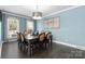 Dining room with light blue walls, a large window, and a wooden table with seating for eight at 3203 Thayer Dr, Waxhaw, NC 28173