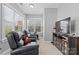 Bright sitting room with two leather recliners, an exercise bicycle, and a mounted television at 3203 Thayer Dr, Waxhaw, NC 28173