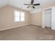 Bedroom with ceiling fan, neutral walls, carpet flooring, and natural light from a window at 3274 Roberta Farms Sw Ct, Concord, NC 28027