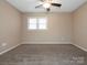 Bedroom featuring a ceiling fan, neutral walls, carpet flooring, and natural light from the window at 3274 Roberta Farms Sw Ct, Concord, NC 28027