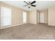 Comfortable bedroom with neutral paint, carpet flooring, bright windows, and ample closet space at 3274 Roberta Farms Sw Ct, Concord, NC 28027