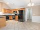 Spacious kitchen featuring wood cabinets, modern appliances, ample counter space, and tile floors at 3274 Roberta Farms Sw Ct, Concord, NC 28027