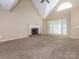 Bright living room with vaulted ceilings, a large window, a ceiling fan and a brick fireplace at 3274 Roberta Farms Sw Ct, Concord, NC 28027