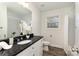 A bathroom features a black granite countertop and a shower with white tile surround at 329 Gurley Nw Dr, Concord, NC 28027