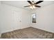 Bright bedroom with a ceiling fan, plush carpet, and a large window offering natural light at 329 Gurley Nw Dr, Concord, NC 28027