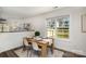 Cozy dining area with a wooden table, modern chairs, and a bright window overlooking the backyard at 329 Gurley Nw Dr, Concord, NC 28027