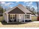 Charming one-story home with light gray siding and a cozy front porch at 329 Gurley Nw Dr, Concord, NC 28027