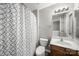 Cozy bathroom featuring a shower with patterned curtain and wooden vanity at 4221 Coulter Xing, Charlotte, NC 28213