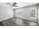 Bright bedroom features new flooring, ceiling fan, and plenty of natural light at 4221 Coulter Xing, Charlotte, NC 28213