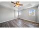 Spacious bedroom features a tray ceiling, ceiling fan, and natural lighting at 4221 Coulter Xing, Charlotte, NC 28213