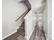 Inviting entryway with wood-look flooring, a staircase with wooden handrail, and neutral paint at 4221 Coulter Xing, Charlotte, NC 28213