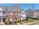 Exterior view of the two-story home with brick and white siding and landscaped lawn at 4221 Coulter Xing, Charlotte, NC 28213