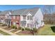 Exterior view of the two-story home with brick and white siding with a well-manicured lawn at 4221 Coulter Xing, Charlotte, NC 28213