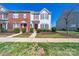 Charming two-story townhome with red shutters and a landscaped front yard on a bright, sunny day at 4221 Coulter Xing, Charlotte, NC 28213