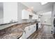 Well-lit kitchen with white cabinets, black appliances, and wood-look floors at 4221 Coulter Xing, Charlotte, NC 28213