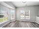 Cozy living room bathed in natural light through large windows, complemented by wood-look floors at 4221 Coulter Xing, Charlotte, NC 28213