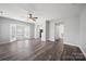 Open-concept living room with wood flooring, connecting seamlessly to the kitchen and dining areas at 4221 Coulter Xing, Charlotte, NC 28213