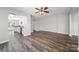 Spacious living room with wood-look floors flowing into the adjacent kitchen with white cabinetry at 4221 Coulter Xing, Charlotte, NC 28213