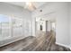 Bright living room with vaulted ceiling, natural light, luxury vinyl plank flooring, and access to the patio at 4221 Coulter Xing, Charlotte, NC 28213