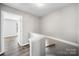 Upstairs hallway with wood flooring, leading to various rooms at 4221 Coulter Xing, Charlotte, NC 28213