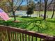 Scenic waterfront view with an American flag, lush lawn, and a private dock at 4300 Pointe Norman Dr, Sherrills Ford, NC 28673