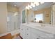 Bright bathroom with double sinks, hardwood floors, and a glass-enclosed shower for modern convenience at 4300 Pointe Norman Dr, Sherrills Ford, NC 28673