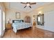 Comfortable bedroom featuring hardwood flooring, a ceiling fan, and a stylish decorative mirror at 4300 Pointe Norman Dr, Sherrills Ford, NC 28673