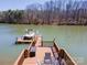 The spacious backyard dock has a boat, slide, seating, and lake access at 4300 Pointe Norman Dr, Sherrills Ford, NC 28673