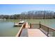 Private dock with a boat, slide, and waterfront access at 4300 Pointe Norman Dr, Sherrills Ford, NC 28673