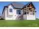 Striking white brick exterior with a covered porch and walkout basement creating an inviting outdoor space at 4412 Holly Ne Cir, Conover, NC 28613