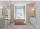 Bright bathroom featuring a soaking tub by the window, sleek vanities, and modern fixtures at 4412 Holly Ne Cir, Conover, NC 28613