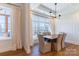 Dining room features hardwood floors, modern lighting, and large window for natural light at 4412 Holly Ne Cir, Conover, NC 28613