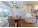 Dining room with white wainscoting and contemporary chandelier fixture at 4412 Holly Ne Cir, Conover, NC 28613