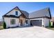 Beautiful new construction home features a brick facade, black trim, a dark roof and an attached garage at 4412 Holly Ne Cir, Conover, NC 28613