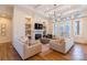 Bright living room with hardwood floors, fireplace, built-in shelves and a cozy seating arrangement at 4412 Holly Ne Cir, Conover, NC 28613