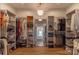 Spacious walk-in closet with custom shelving, a chandelier, and a full-length mirror at 4412 Holly Ne Cir, Conover, NC 28613