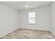 Well-lit bedroom with a ceiling fan, window, and durable flooring at 4513 Staffordshire Ln, Charlotte, NC 28213