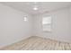 Bright bedroom featuring a modern ceiling fan, window, and light wood-look flooring at 4513 Staffordshire Ln, Charlotte, NC 28213