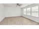 Bright bedroom featuring light wood flooring, neutral walls and three windows offering plenty of natural light at 4513 Staffordshire Ln, Charlotte, NC 28213