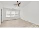 This bedroom offers natural light and light wood-look flooring at 4513 Staffordshire Ln, Charlotte, NC 28213