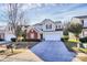 Charming two-story home with a brick accent, a well-manicured lawn, and a spacious driveway at 4513 Staffordshire Ln, Charlotte, NC 28213