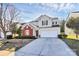 Charming two-story home with a brick accent, a well-manicured lawn, and a spacious driveway at 4513 Staffordshire Ln, Charlotte, NC 28213