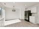 Kitchen features modern appliances, white cabinets and adjacent dining area at 4513 Staffordshire Ln, Charlotte, NC 28213